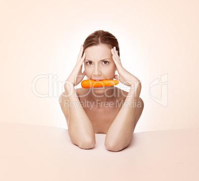 Beautiful woman with carrot in her mouth