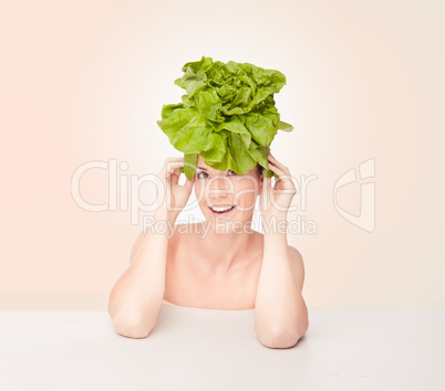 Fun portrait of a woman wearing a lettuce