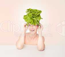 Fun portrait of a woman wearing a lettuce
