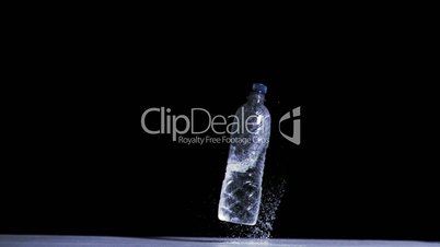 Bottle falling in super slow motion while filled with water