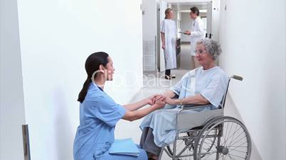 Nurse looking at a patient in a wheelchair