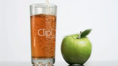 Fresh apple juice being poured in super slow motion