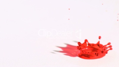Red drop splashing in super slow motion