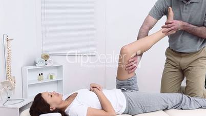 Physiotherapist working on the leg of his patient