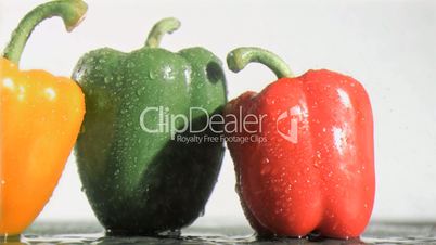 Delicious peppers in super slow motion receiving raindrops