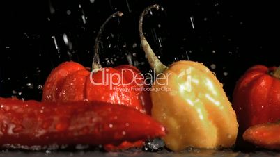 Raindrops falling in super slow motion on vegetables
