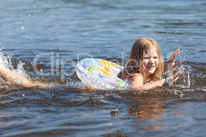 portrait of a beautiful little girl with a color lifebuoy