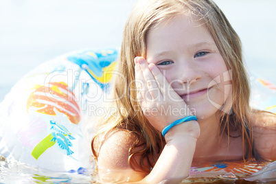 portrait of a beautiful little girl with a color lifebuoy