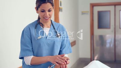 Nurse holding hand of a female patient