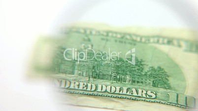 Magnifying glass floating over a dollar bill