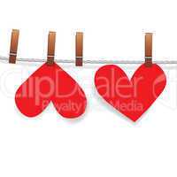 Red paper heart attached to a clothesline with pin