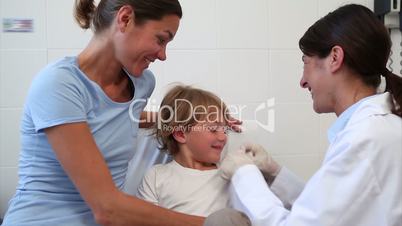 Serious doctor giving child an injection
