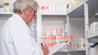 Pharmacist standing behind a hospital counter