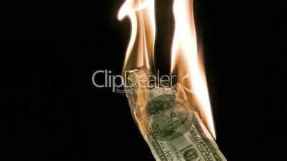 Fire in super slow motion burning a bank note