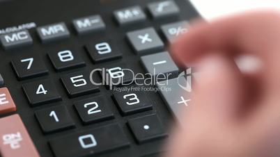 Somebody typing on a calculator