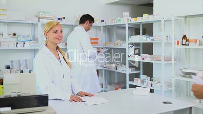 Someone giving a prescription to a pharmacist
