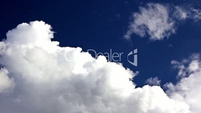 Time lapse clouds over blue sky