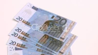 Twenty euro banknotes spread in super slow motion
