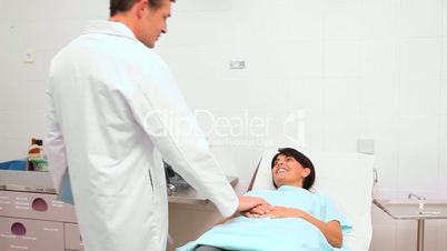 Doctor looking at a folder next to a patient