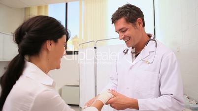 Doctor doing a bandage to a patient