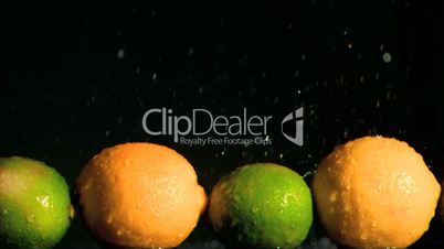 Lemons and limes in super slow motion receiving water