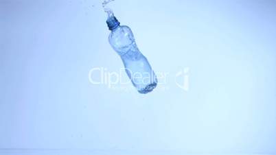 Plastic bottle falling in super slow motion with water