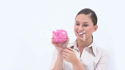 Businesswoman holding a piggy bank