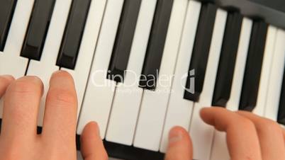 Fingers touching piano keys