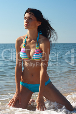 portrait girl in swimsuit on coast sea