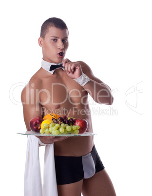 athletic man like striptease waiter hold fruits
