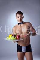 muscular man waiter offer fruits