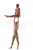 two men stand on heavy gymnastic performance