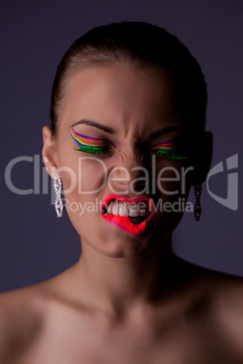 Beauty and anger woman portrait with uv cosmetics
