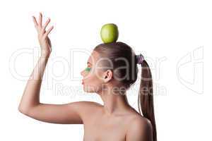 Pretty woman take green apple on head