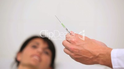 Doctor preparing an injection for a patient