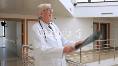 Male doctor looking at a x-ray in the hallway