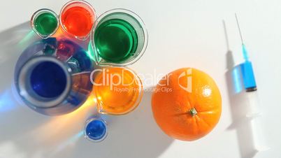 Chemist placing a blue liquid in an orange