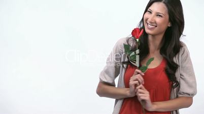 Smiling woman holding a rose