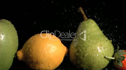 Drops in super slow motion falling on fruits