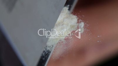 Cocaine being prepared with a razor