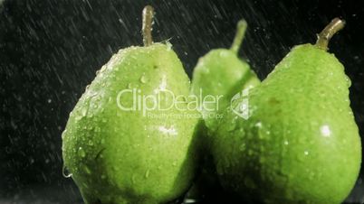Raindrops in super slow motion falling on pears