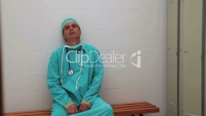 Irritated surgeon sitting on a bench