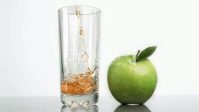 Fresh apple juice poured in super slow motion