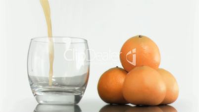 Mandarin smoothie poured in super slow motion