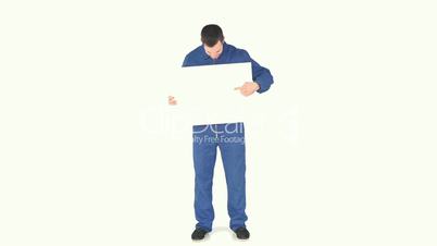 Man wearing overall and holding a blank board
