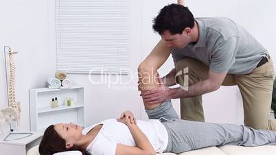 Therapist massaging the thigh of his patient