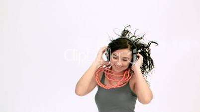 Brunette jumping in slow motion while listening to music