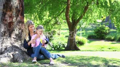 Girl and her mother doing bubbles