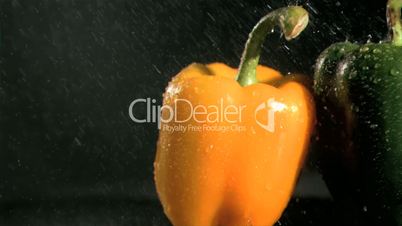 Tasty peppers in super slow motion receiving water