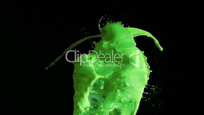 Green sprays of paint in super slow motion rising